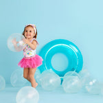 Child playing with balloons against a light blue background