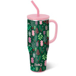 Extra-large insulated mug in green glitter with pink, green, and red mistletoe and holly design, pink handle, and Swig logo