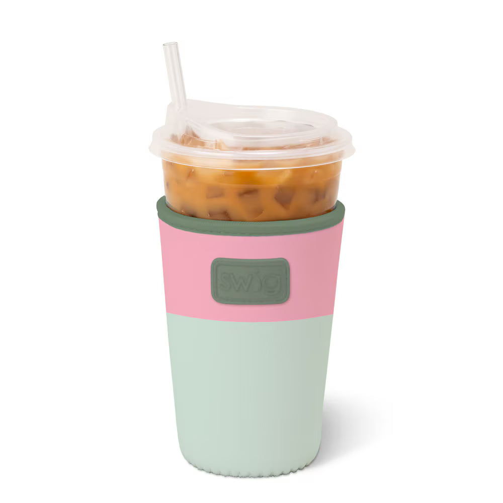 Medium neoprene iced drink sleeve in sage green with pink trim and Swig logo