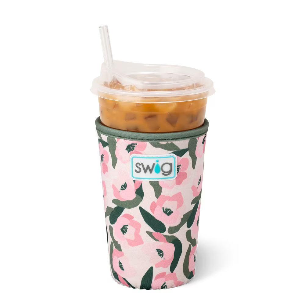 Pink and olive floral neoprene drink sleeve holding an iced coffee cup