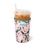 Pink and olive floral neoprene drink sleeve holding an iced coffee cup