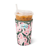 Pink and olive floral neoprene drink sleeve holding an iced coffee cup