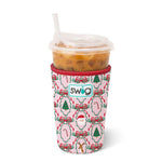 Medium neoprene iced drink sleeve with pink background, Christmas icons, and red trim, holding iced coffee