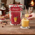 Blitzen Bourbon holiday slush mix pouch with cocktail glass by fireplace.
