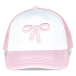 White and pink bow trucker hat with embroidered bow detail, mesh back, and adjustable strap.