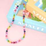 Colorful beaded necklace on a magazine with 'AMALEFI' branding
