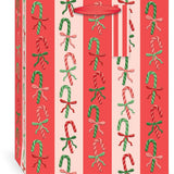 Punch Studio Candy Cane Lane Large Vertical Premium Gift Bag with embossed candy cane pattern and red grosgrain handle.