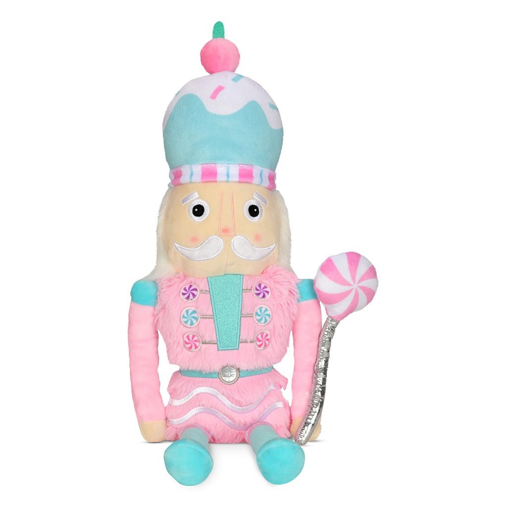 Candy Nutcracker plush toy in pastel pink, teal, and white with candy details, faux fur, fleece, and glitter embroidery, measuring 18 inches tall.