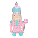 Candy Nutcracker plush toy in pastel pink, teal, and white with candy details, faux fur, fleece, and glitter embroidery, measuring 18 inches tall.