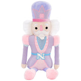 Pastel Nutcracker plush toy in pink, purple, and blue with faux fur trim, metallic accents, and embroidered details.