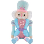 Chris Nutcracker plush toy in pastel blue and pink with faux fur, glitter accents, and embroidered details.