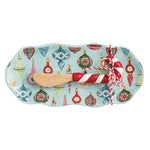 Blue ceramic tray with vintage ornament pattern and candy cane–handled wooden spreader.