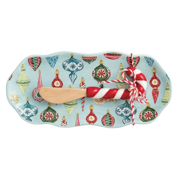 Blue ceramic tray with vintage ornament pattern and candy cane–handled wooden spreader.