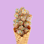 Waffle cone filled with colorful ice cream balls on a purple background