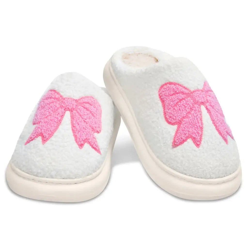 Children’s Cozy Bow slippers made of chenille with pink embroidered bow design and skid-resistant sole.