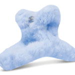 Clear zip pouch containing four plush fuzzy hair clips in pastel white, pink, purple, and blue