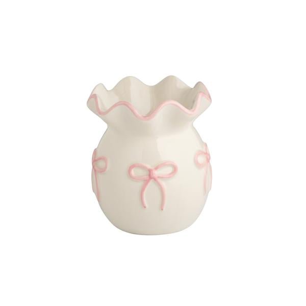 White ceramic bud vase with pink bows and ruffled edge.