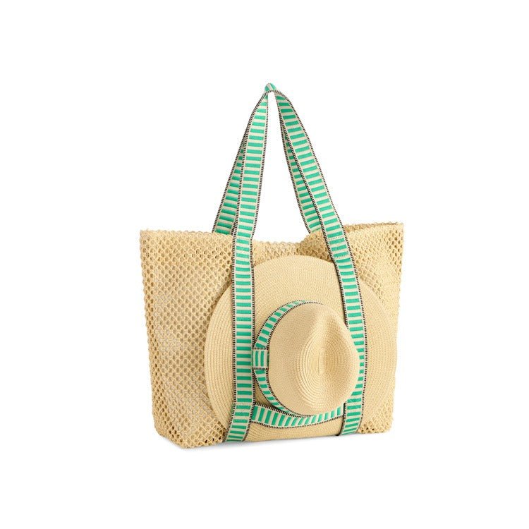 Beige woven tote bag with green striped handles on a white background