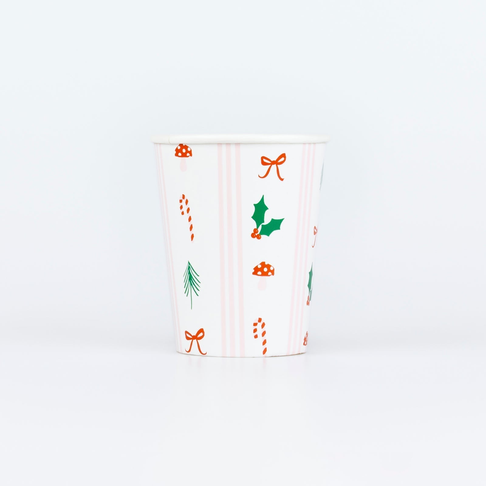 Christmas paper cups with candy cane, holly, bow, and mushroom holiday icons in red, green, and pink stripes