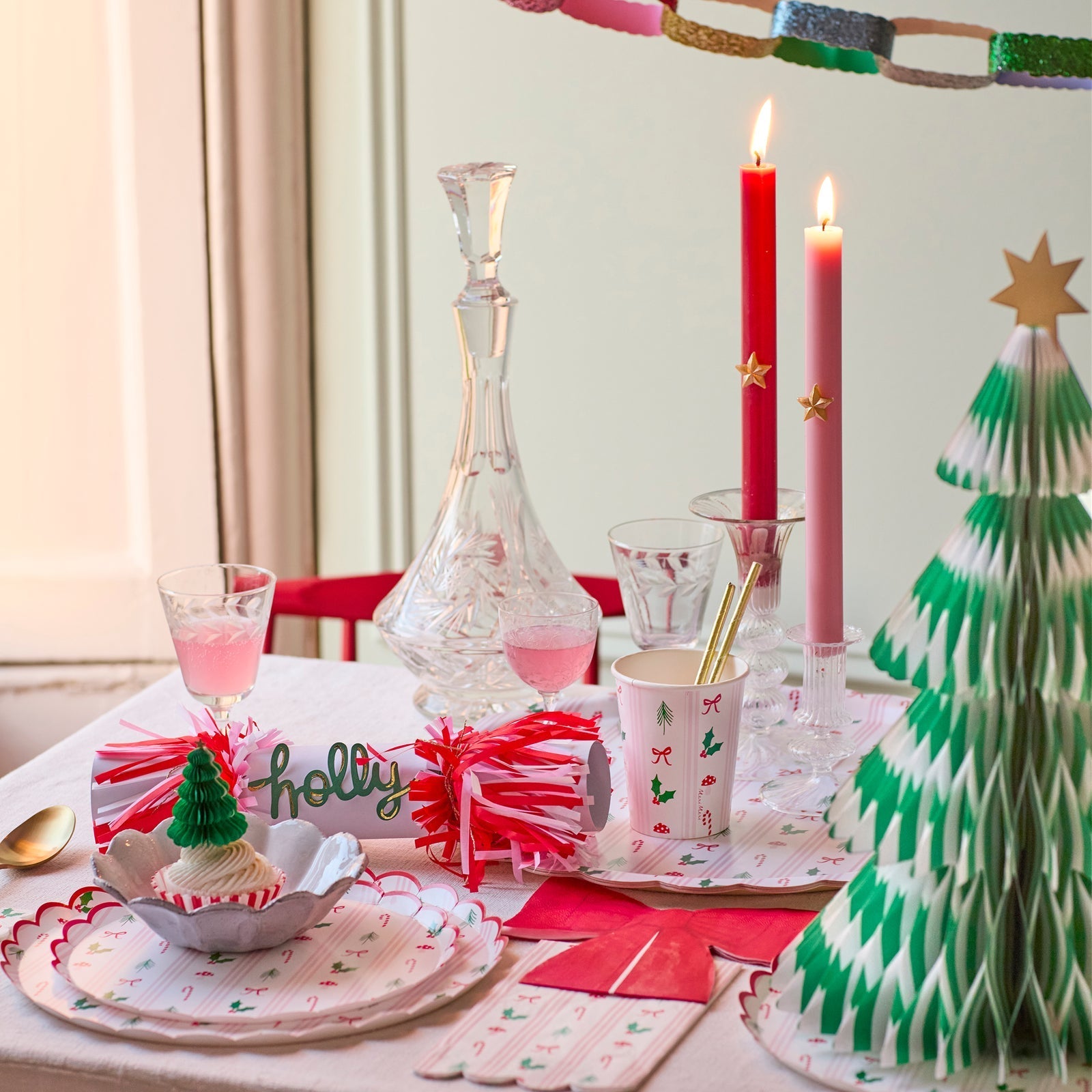 Christmas paper cups with candy cane, holly, bow, and mushroom holiday icons in red, green, and pink stripes