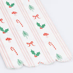 Christmas paper guest towel with red and green holiday icons and pink stripes