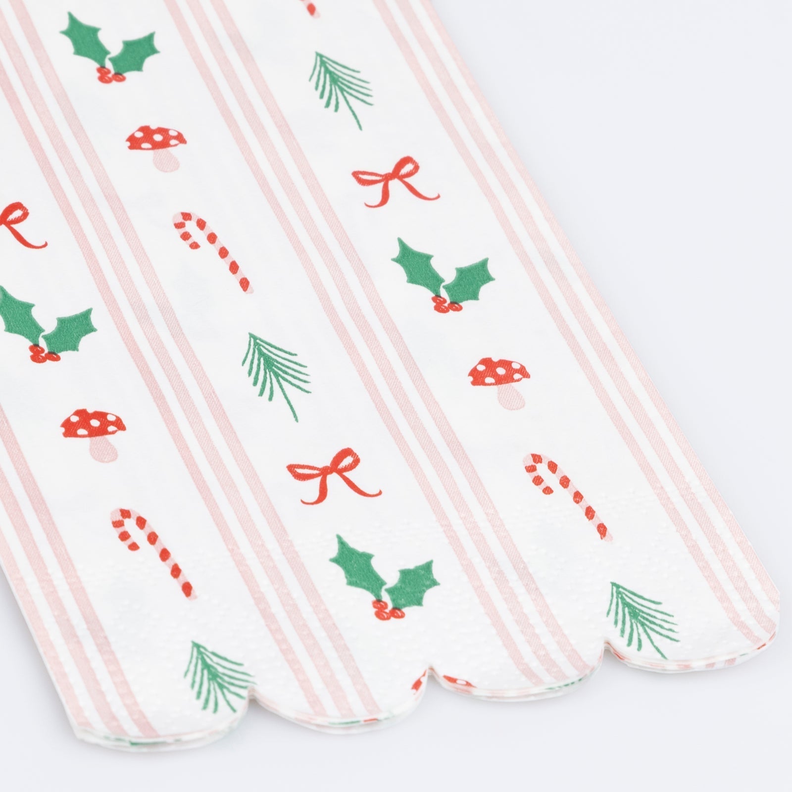 Christmas paper guest towel with red and green holiday icons and pink stripes