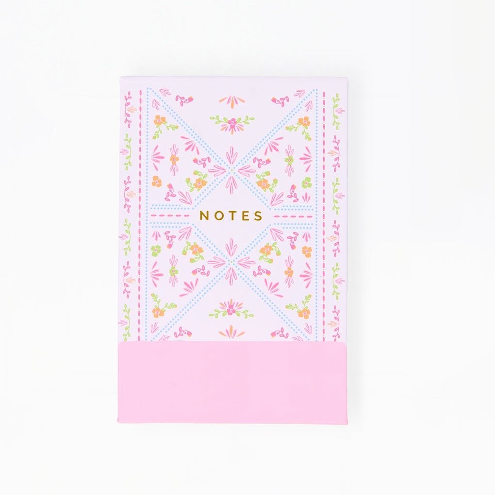 Floral notebook with pink bottom section on a white background