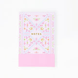 Floral notebook with pink bottom section on a white background