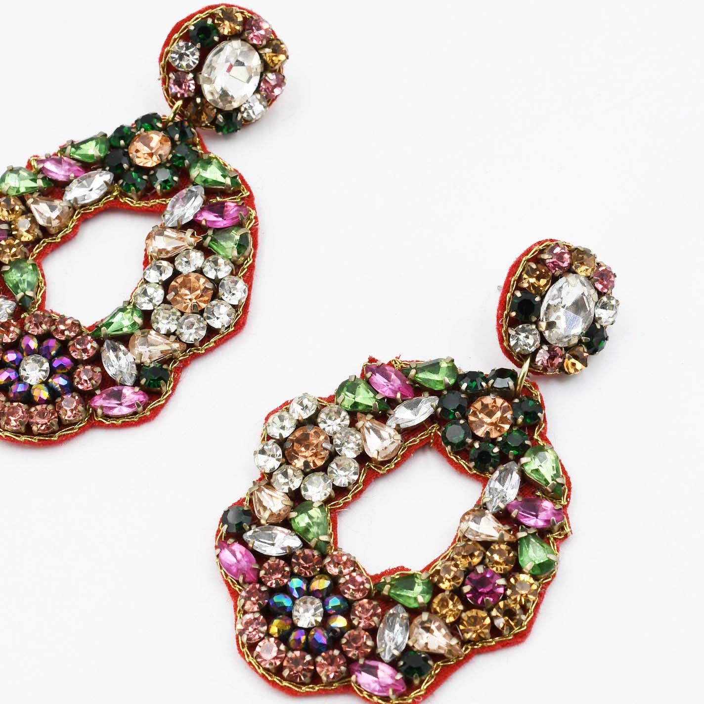 Multicolored gemstone earrings on a white background