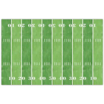 Green rectangular placemat designed like a football field with white yard lines and numbers