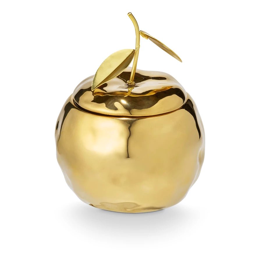 Gilded Citrus candle in a shiny gold apple-shaped jar with sculpted leaves