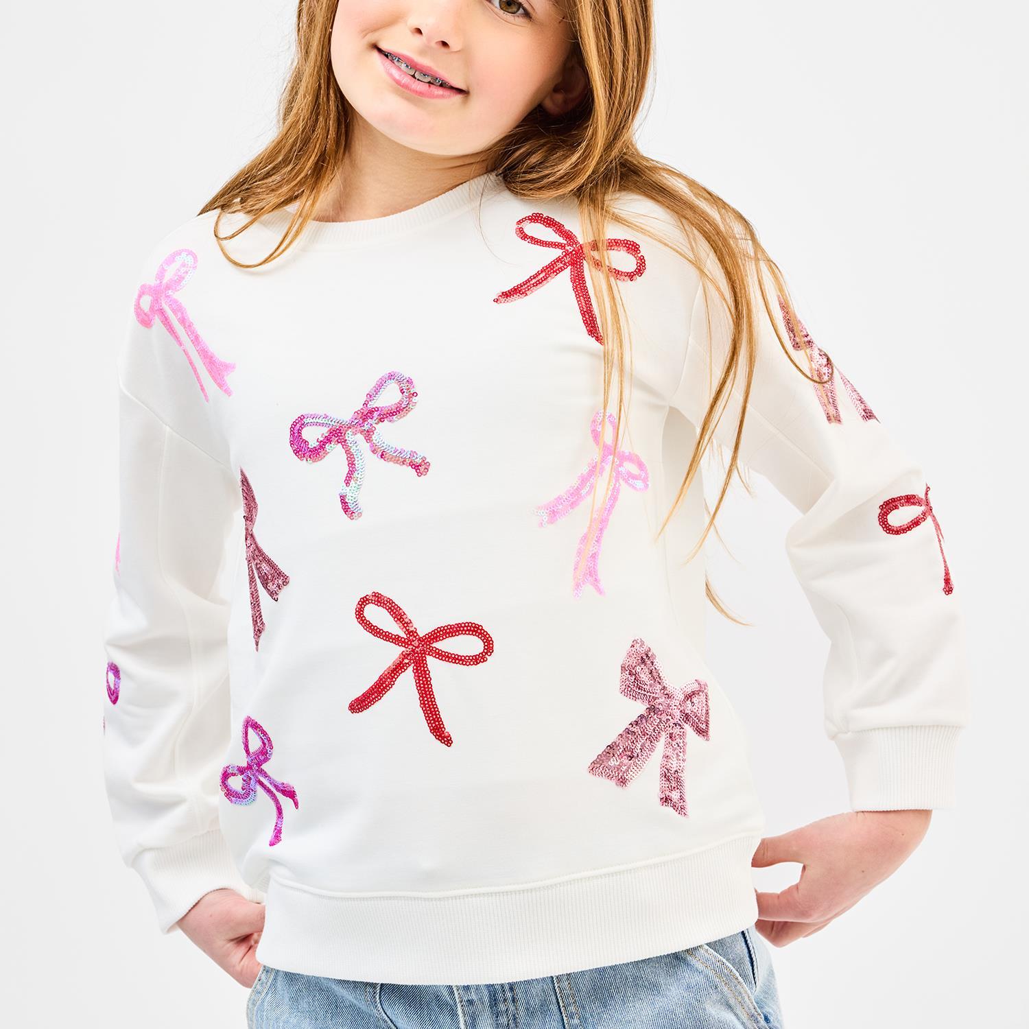 White youth sweatshirt with sparkly pink, red, and purple sequin bow designs