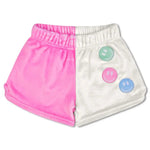 Children’s color block shorts in pink and white with smiley face patches and back pocket