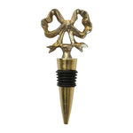 Gold bow wine stopper by Mary Square, elegant bar accessory for holiday entertaining.