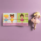 Children's book with illustrations of ballerinas on a purple background, accompanied by a doll in a ballet outfit.