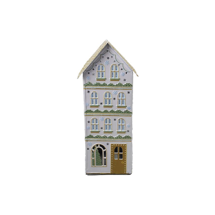 Decorative tall painted metal holiday house with cut-out windows and gold door