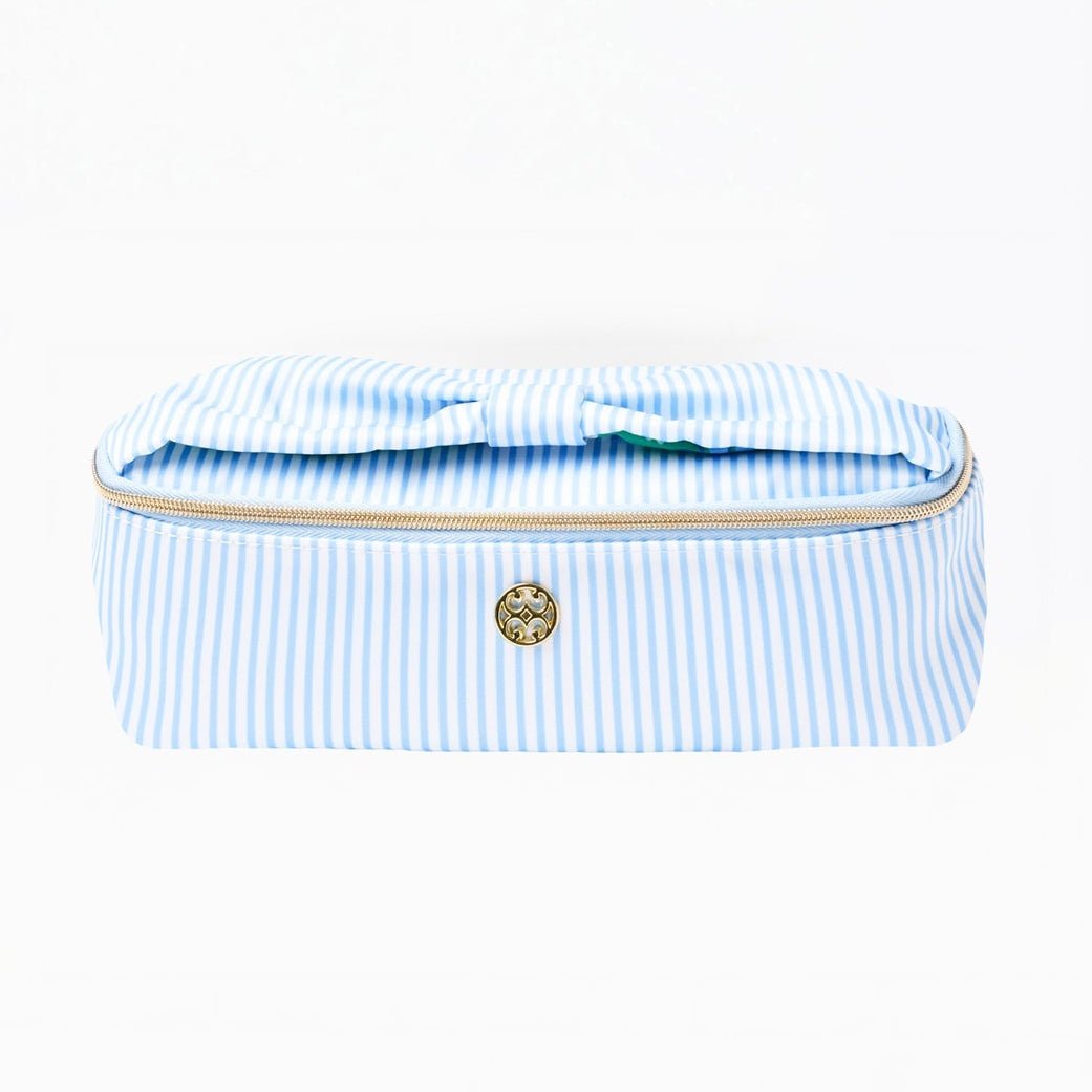 Blue and white striped toiletry bag with gold zipper on a white background