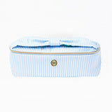 Blue and white striped toiletry bag with gold zipper on a white background