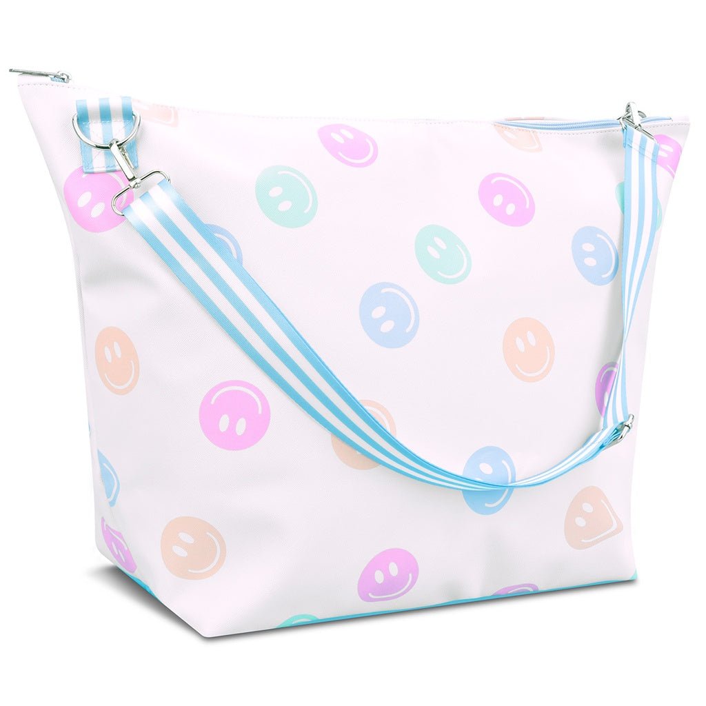 White weekender bag with pastel smiley face print and blue striped adjustable strap