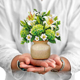 Pop-Up Card
Alt Image Text: Hands holding a mini pop-up bouquet of white lilies, green hydrangeas, and eucalyptus in a stone vase