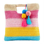 Colorful striped crochet bag with pom-poms and tassels on a white background
