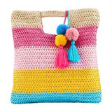 Colorful striped crochet bag with pom-poms and tassels on a white background