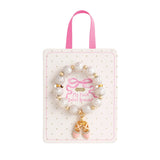 pink and white beaded stretch bracelets for kids with ballet slipper and bow enamel charms on display cards