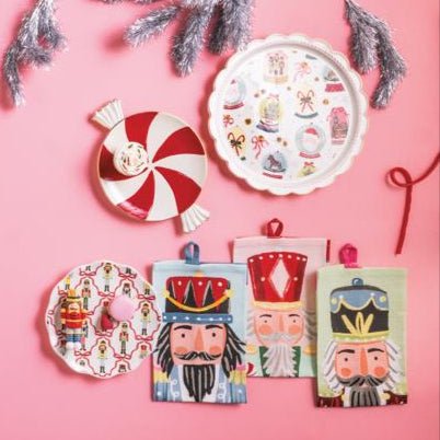 Hand-painted nested Christmas candy platters featuring a red peppermint swirl and festive holiday icons