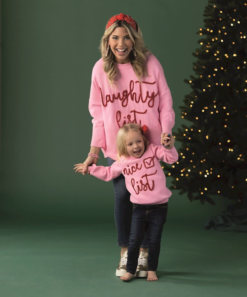 Pink toddler sweatshirt with “nice list” tinsel lettering and check mark design