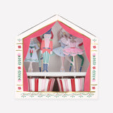 Nutcracker Ballet cupcake kit with character toppers and red, pink, and white striped cases in stage-themed box