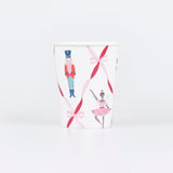 Nutcracker Ballet paper cups with dancers, toy soldiers, and festive ribbon bows in red, pink, and gold