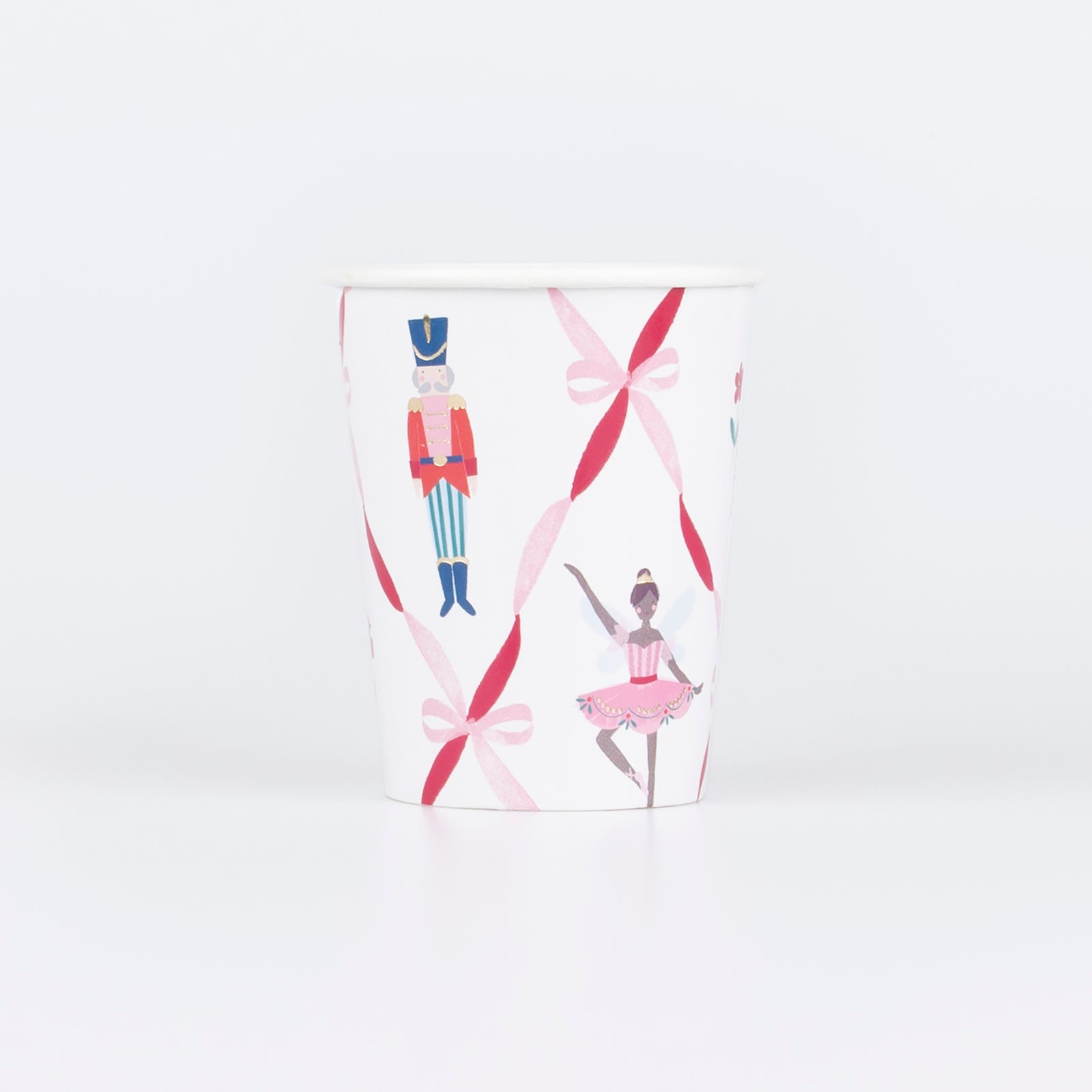 Nutcracker Ballet paper cups with dancers, toy soldiers, and festive ribbon bows in red, pink, and gold