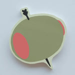 Olive-shaped die-cut sticky note pad with pimento and toothpick design by Idlewild Co.