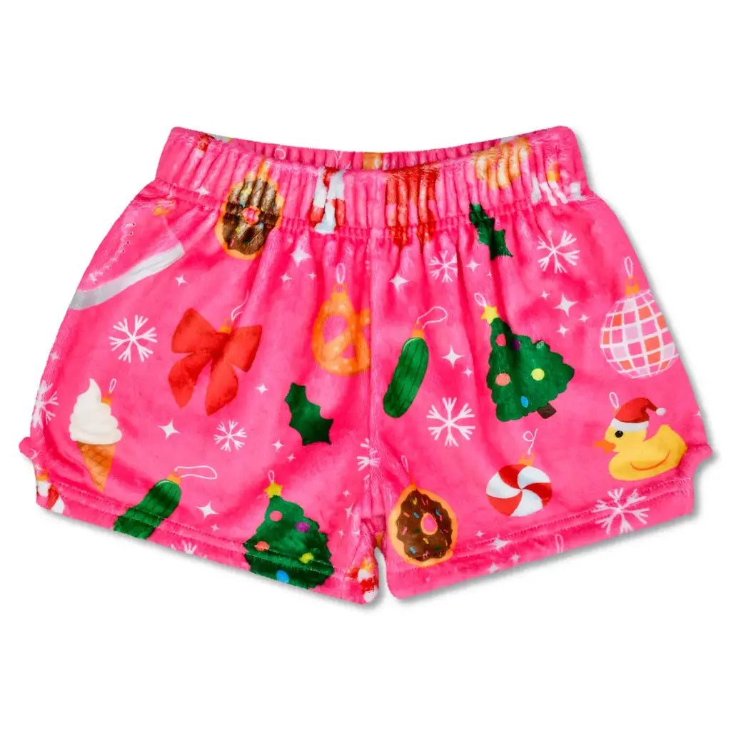 Children’s Ornament plush shorts with festive holiday print featuring ornaments, bows, Christmas trees, and treats on pink fabric.